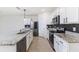 Stylish kitchen boasts white cabinets, granite countertops, and stainless steel appliances with backsplash at 4203 San Rocco Way, Winter Haven, FL 33884