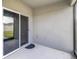 The covered patio features a screen door to the spacious, fenced backyard at 4203 San Rocco Way, Winter Haven, FL 33884