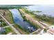Picturesque aerial view of a canal and lakefront community featuring a boat dock and waterfront living at 4540 Park Ave, Indian Lake Estates, FL 33855