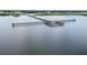 An aerial shot of a gorgeous pier sitting on a peaceful body of water at 4540 Park Ave, Indian Lake Estates, FL 33855