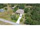 Aerial view of a private residence with mature trees, a pool and a long driveway at 4540 Park Ave, Indian Lake Estates, FL 33855