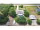 Aerial shot of home with a pool surrounded by beautiful landscaping at 4540 Park Ave, Indian Lake Estates, FL 33855