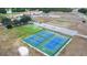 Beautiful aerial view of a recreational area with tennis courts, a parking lot, and landscaped grounds at 4540 Park Ave, Indian Lake Estates, FL 33855