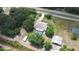 This overhead view showcases the large property, pool, carport, and other outdoor buildings at 4540 Park Ave, Indian Lake Estates, FL 33855