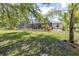 Backyard featuring a screened-in pool, lush greenery, and a serene outdoor space perfect for relaxation and entertainment at 4540 Park Ave, Indian Lake Estates, FL 33855