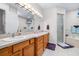 Well-lit bathroom featuring a double sink vanity and a separate shower and tub at 4540 Park Ave, Indian Lake Estates, FL 33855