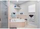 Cozy bathroom featuring a corner tub, a stand-alone shower, and natural light at 4540 Park Ave, Indian Lake Estates, FL 33855