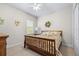 Bright bedroom featuring a floral bedspread, a window, and ample natural light at 4540 Park Ave, Indian Lake Estates, FL 33855
