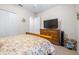 Comfortable bedroom featuring a large bed, closet, and a television on a dresser at 4540 Park Ave, Indian Lake Estates, FL 33855