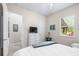 Bright bedroom featuring a light comforter, a television on a dresser, and natural light at 4540 Park Ave, Indian Lake Estates, FL 33855