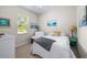 Bright bedroom featuring a white comforter, a nightstand, and natural light at 4540 Park Ave, Indian Lake Estates, FL 33855