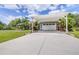Attached carport and two-car garage provide ample covered parking at this lovely Florida home at 4540 Park Ave, Indian Lake Estates, FL 33855