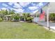 Single-story home with a lush green lawn, side-entry garage and well maintained landscaping at 4540 Park Ave, Indian Lake Estates, FL 33855