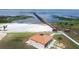 Aerial view of a beachfront recreational area with sandy beach, fishing pier, and restroom building at 4540 Park Ave, Indian Lake Estates, FL 33855