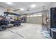Spacious garage with a golf cart, storage shelves, and a convenient refrigerator for refreshments at 4540 Park Ave, Indian Lake Estates, FL 33855