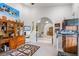 Bright office featuring built-in shelving, neutral carpet, and an archway leading to the foyer at 4540 Park Ave, Indian Lake Estates, FL 33855