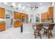 Bright kitchen with light brown cabinets, granite countertops, and breakfast bar at 4540 Park Ave, Indian Lake Estates, FL 33855