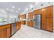 Well-lit kitchen with wooden cabinets, stainless steel appliances, and lots of counter space at 4540 Park Ave, Indian Lake Estates, FL 33855