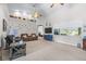 Bright living room featuring high ceilings, neutral carpet, large windows and backyard views at 4540 Park Ave, Indian Lake Estates, FL 33855