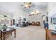 Spacious living room boasting natural light, neutral carpet, high ceilings and stylish decor at 4540 Park Ave, Indian Lake Estates, FL 33855