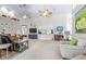 Inviting living room featuring high ceilings, modern ceiling fans, and neutral colored carpet at 4540 Park Ave, Indian Lake Estates, FL 33855