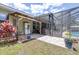 Outdoor patio featuring brick pavers, and a refrigerator for convenient backyard entertaining near the screened-in pool at 4540 Park Ave, Indian Lake Estates, FL 33855