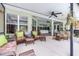 Expansive screened-in patio with cozy seating areas, lush plants, and ample space for entertaining at 4540 Park Ave, Indian Lake Estates, FL 33855