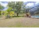 Inviting pool surrounded by lush landscaping, screened-in lanai, creating a private backyard oasis for relaxation at 4540 Park Ave, Indian Lake Estates, FL 33855