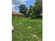 View of backyard with tall grass and weeds at 4885 Cherry Dr, Mulberry, FL 33860