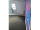 View of a room with bright-colored walls and dark carpet at 4885 Cherry Dr, Mulberry, FL 33860