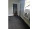 Unfurnished bedroom with window, dark carpet, and an open closet door at 4885 Cherry Dr, Mulberry, FL 33860