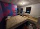 Bedroom needing renovation, featuring a mattress on the floor and colorful wall art at 4885 Cherry Dr, Mulberry, FL 33860