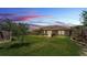 Backyard featuring lush green grass, a patio with furniture, and beautiful landscaping at 4965 Tradition Dr, Lakeland, FL 33812