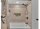 Bright bathroom featuring a tiled shower with a built-in niche for toiletries at 4965 Tradition Dr, Lakeland, FL 33812