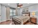 Inviting bedroom with hardwood floors, a comfortable bed, and plenty of natural light at 4965 Tradition Dr, Lakeland, FL 33812