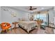 Cozy bedroom with wood floors, ceiling fan, and a neutral color palette at 4965 Tradition Dr, Lakeland, FL 33812