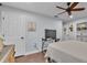 Comfortable bedroom with wood floors, ceiling fan, TV and walk in closet at 4965 Tradition Dr, Lakeland, FL 33812