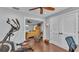 A bedroom and workout area featuring hardwood floors and open access to the bedroom area at 4965 Tradition Dr, Lakeland, FL 33812