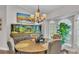Lovely dining area with a decorative chandelier, a large aquarium, and sunlit windows creates an elegant space at 4965 Tradition Dr, Lakeland, FL 33812