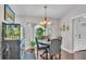 Elegant dining area featuring a round table, chandelier, and a large aquarium, creating a unique, inviting atmosphere at 4965 Tradition Dr, Lakeland, FL 33812