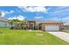 Beautiful one-story home boasting a well-maintained lawn, two-car garage, and a lovely garden enhancing curb appeal at 4965 Tradition Dr, Lakeland, FL 33812