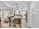 Open concept kitchen with white cabinets, stainless appliances, large island, and open flow to dining and living areas at 4965 Tradition Dr, Lakeland, FL 33812