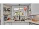 Charming kitchen sink area with a stylish backsplash, stainless steel faucet, and a view to the backyard at 4965 Tradition Dr, Lakeland, FL 33812