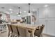 Bright kitchen with island seating, white cabinetry, stainless steel appliances, and connecting dining space at 4965 Tradition Dr, Lakeland, FL 33812