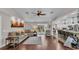Spacious living room with hardwood floors offering a view to the kitchen, outside patio and dining area at 4965 Tradition Dr, Lakeland, FL 33812