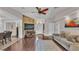 Open-concept living room with hardwood floors, vaulted ceilings, and seamless flow to dining and entrance at 4965 Tradition Dr, Lakeland, FL 33812
