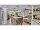 Open concept living space with island seating seamlessly connects the kitchen and living room, promoting a spacious, inviting ambiance at 4965 Tradition Dr, Lakeland, FL 33812