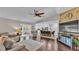 Open floor plan featuring living room with vaulted ceiling leading to the kitchen island and eating area at 4965 Tradition Dr, Lakeland, FL 33812