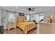 Comfortable primary bedroom featuring a tray ceiling, hardwood floors, and serene lighting; offering a relaxing retreat at 4965 Tradition Dr, Lakeland, FL 33812
