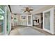 The sunroom has a ceiling fan, tile floors, and access to a full bathroom at 4965 Tradition Dr, Lakeland, FL 33812